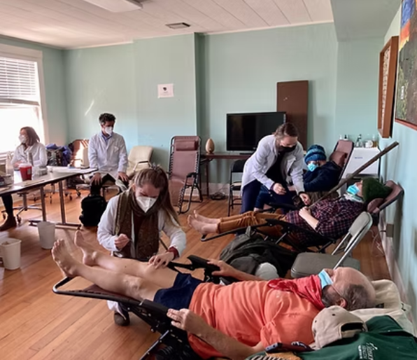 Interns providing free acupuncture to community members reclined in chairs at the Haywood Street clinic